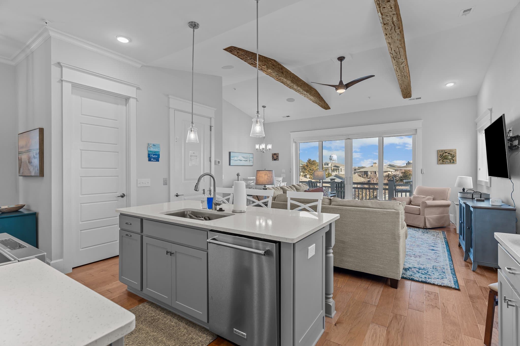 Soaring ceilings with rustic beams, modern kitchen island, and stunning water views.