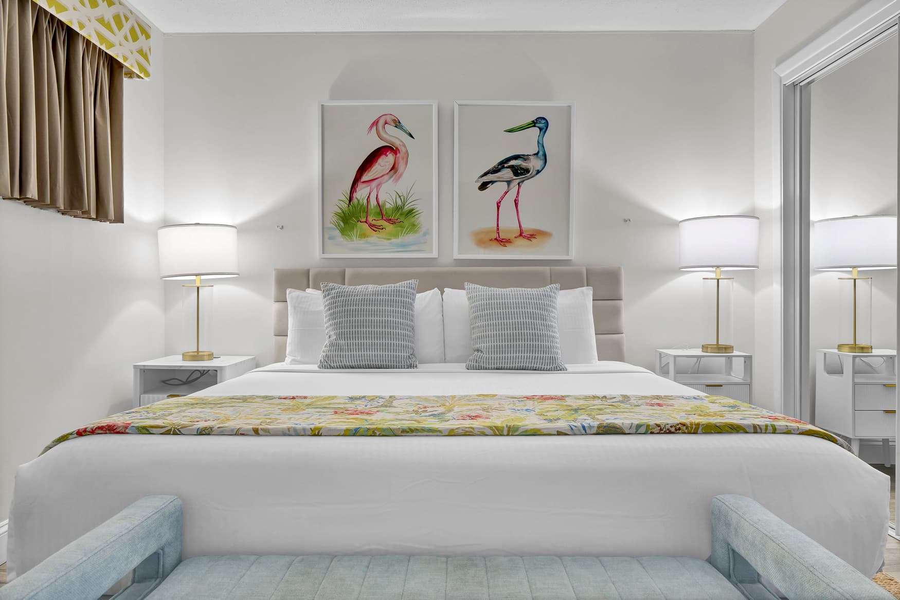 Drift off in your beautifully appointed bedroom, featuring crisp white linens, charming bird artwork, and elegant coastal touches that create a serene retreat.