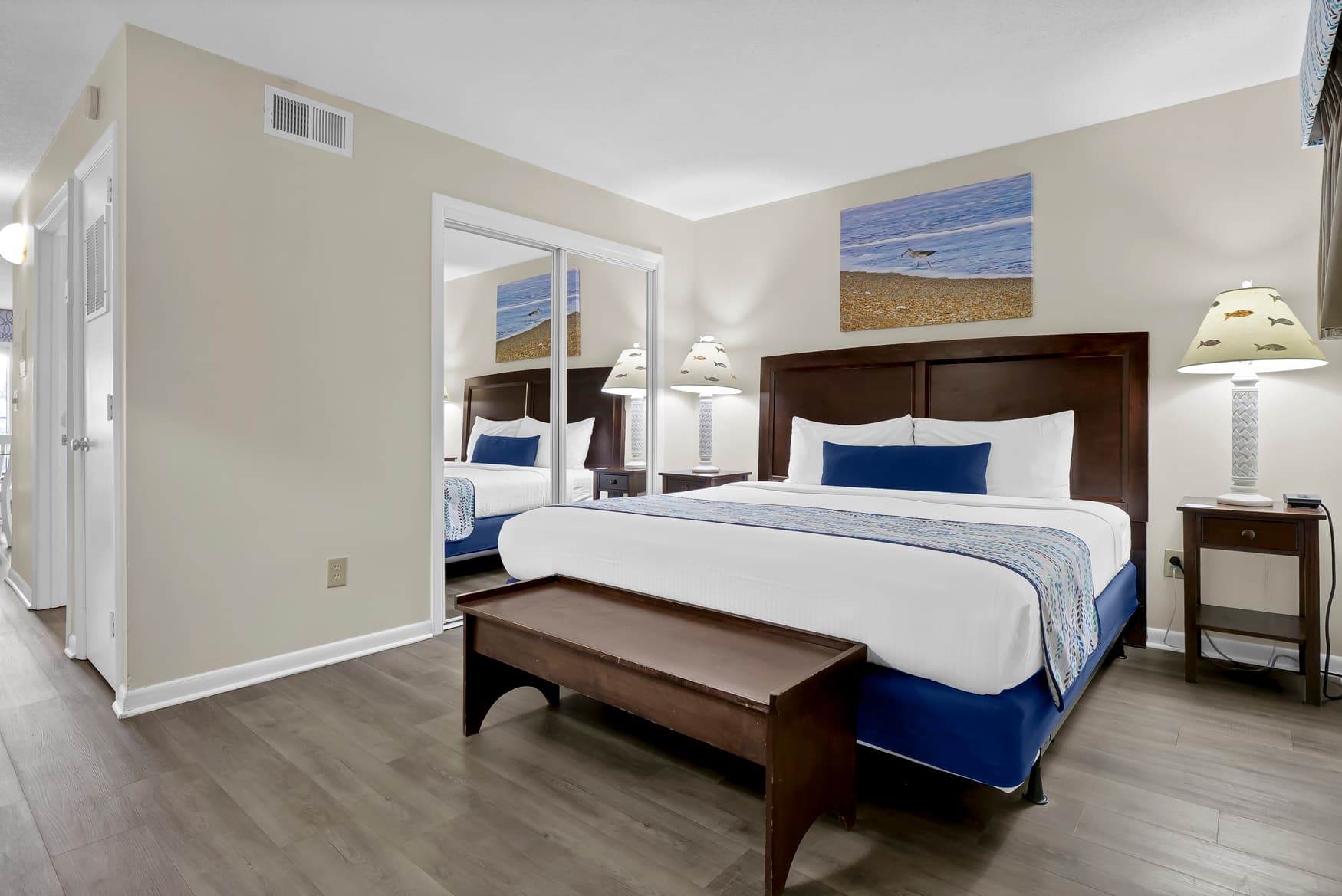 Your spacious bedroom features a comfortable king bed with coastal artwork, creating a peaceful retreat for restful nights.