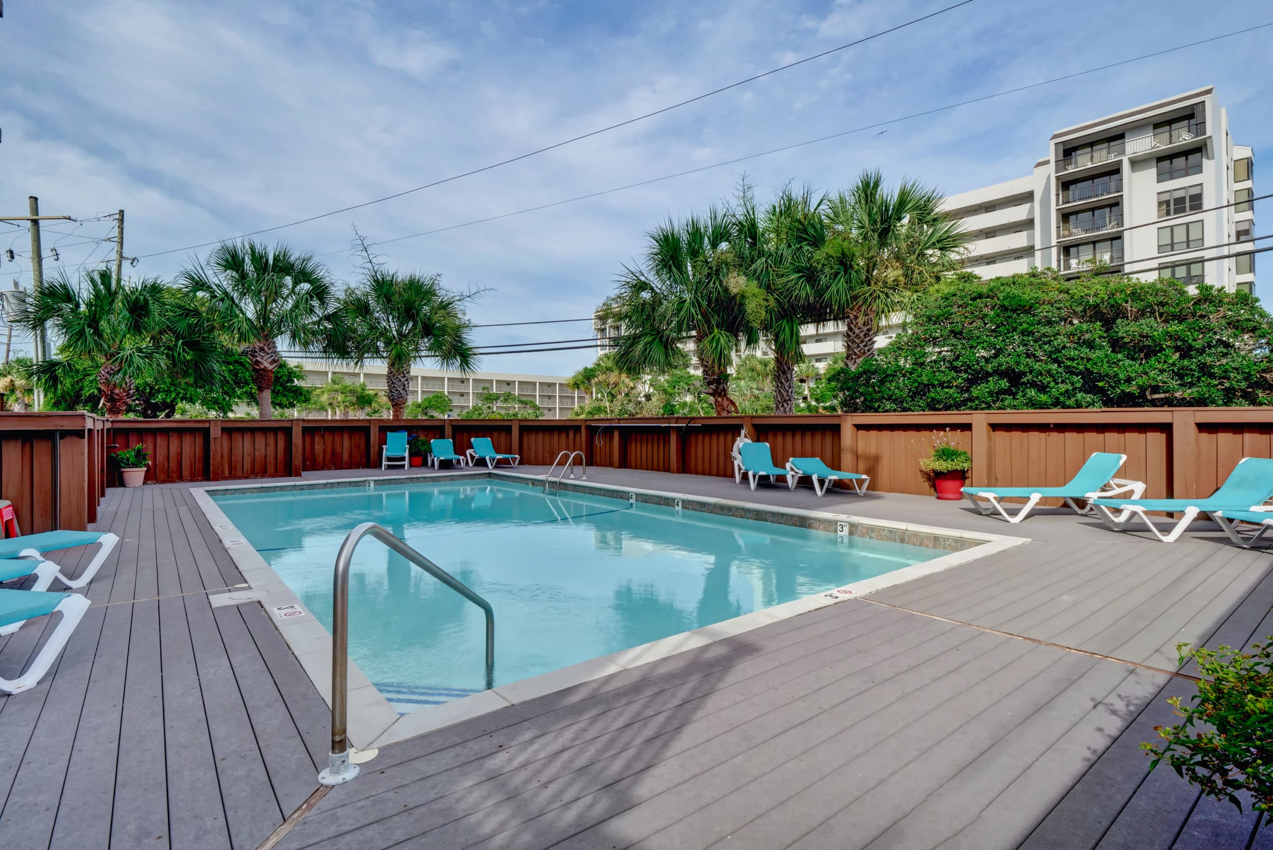 Sparkling resort pool close to the ocean and local tourist attractions.