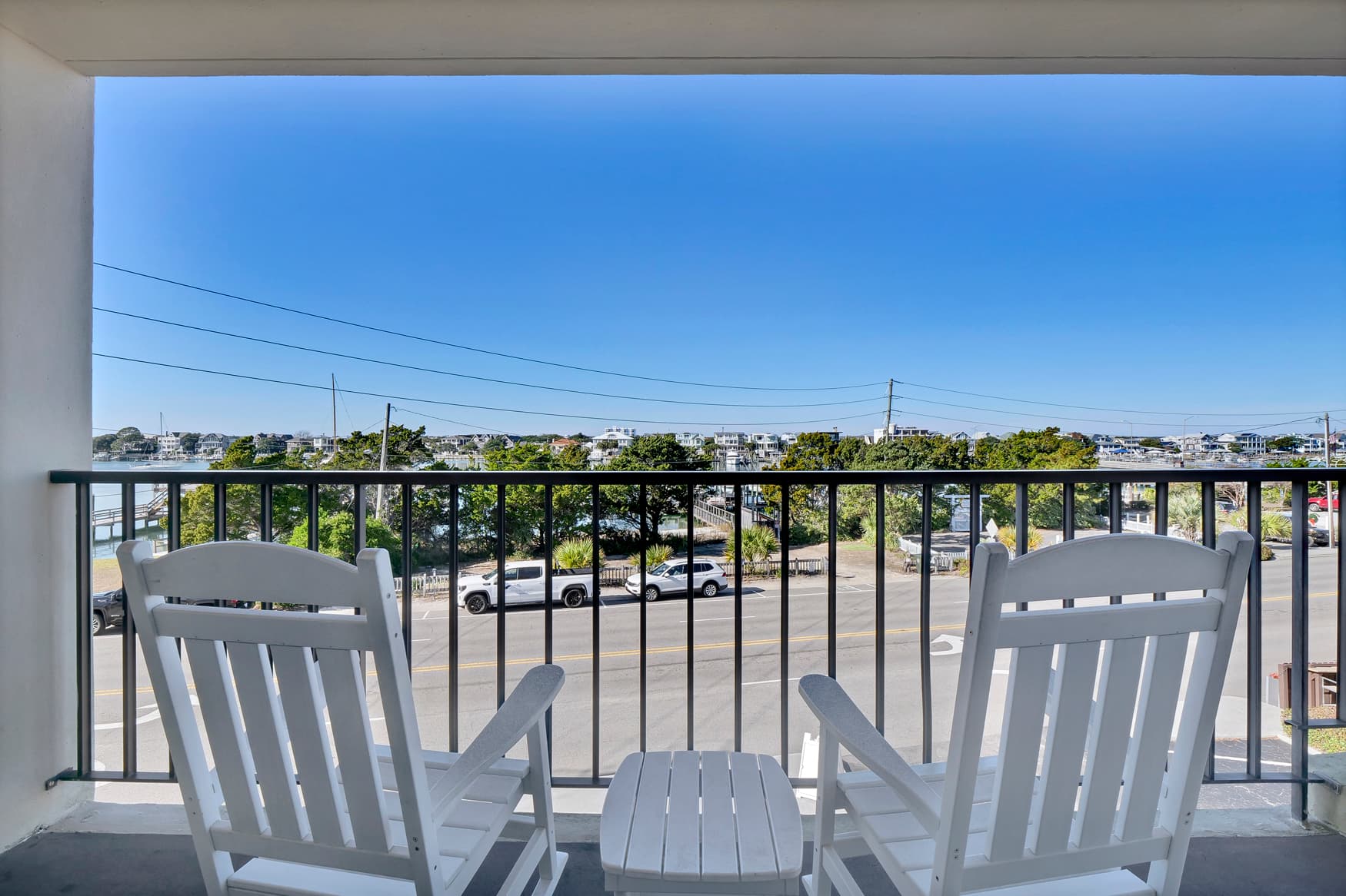 Relax in your comfortable Adirondack chairs on this private balcony, perfectly positioned for enjoying the peaceful view and morning coffee.