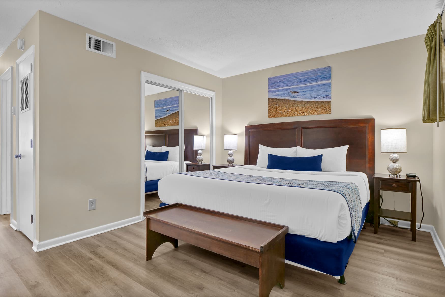 Your serene bedroom features crisp linens, coastal artwork, and warm wood furnishings that create the perfect retreat after your day of exploring.