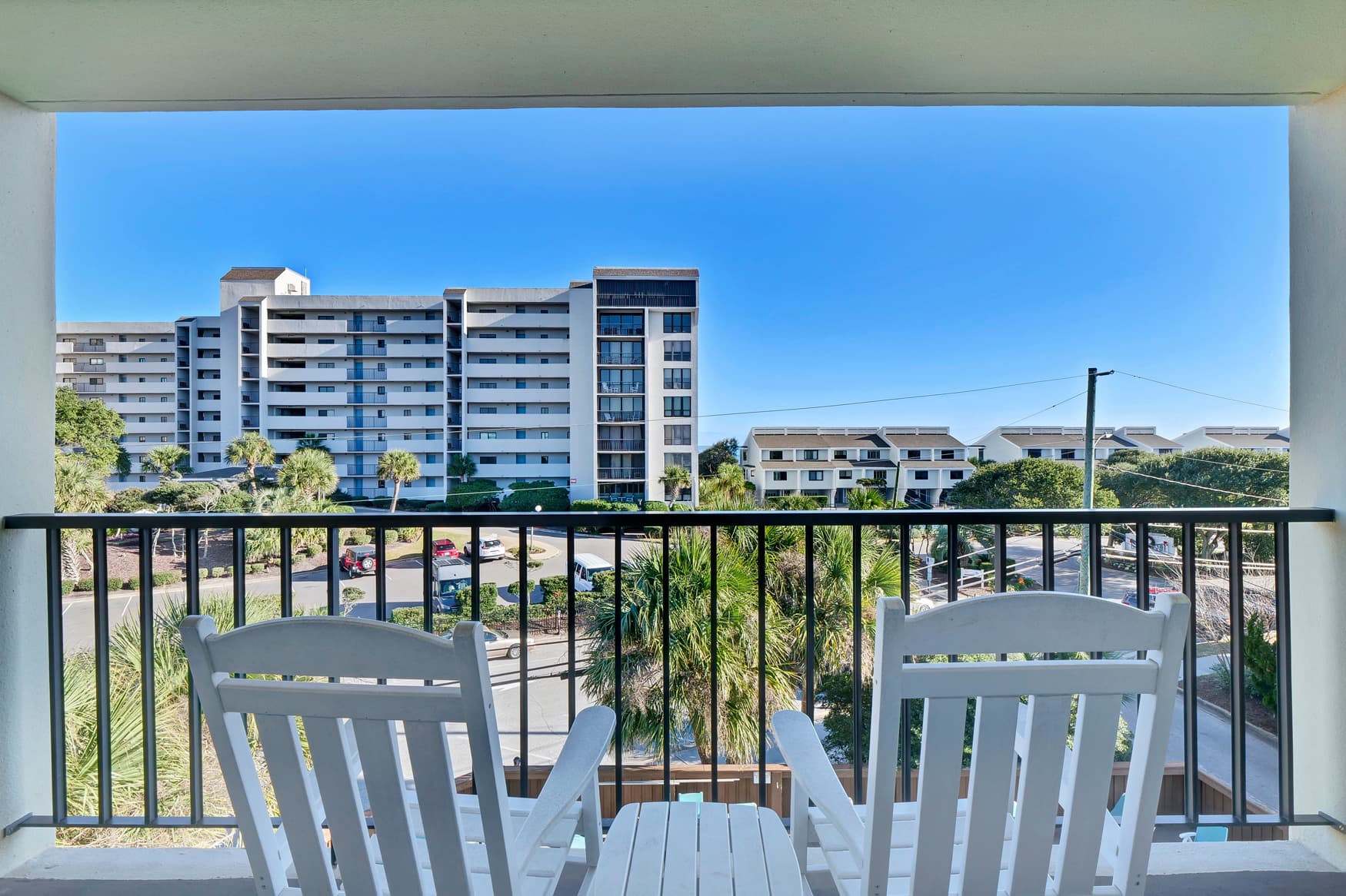 Step out onto your private balcony and enjoy your morning coffee while taking in views of the surrounding residential area and tropical landscaping.