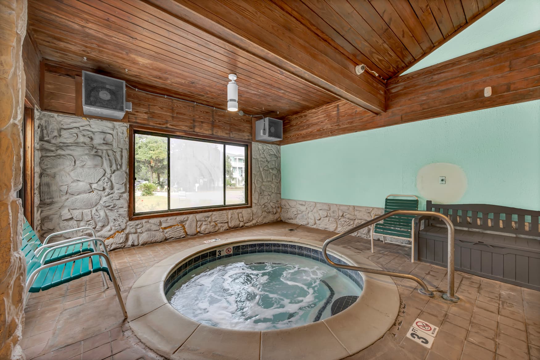 Unwind in your own private hot tub sanctuary, featuring rustic stone walls and warm wood beams that create the perfect atmosphere for relaxation.