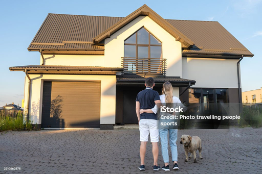 Family standing in front of their coastal home