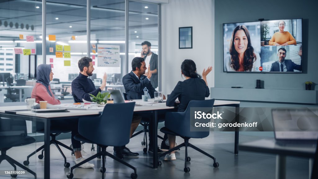 Team on a video call in a modern meeting room