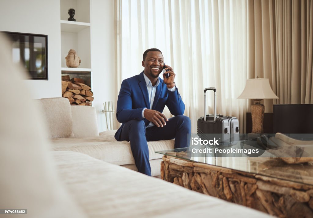 Business traveler on a phone call in a bright rental home
