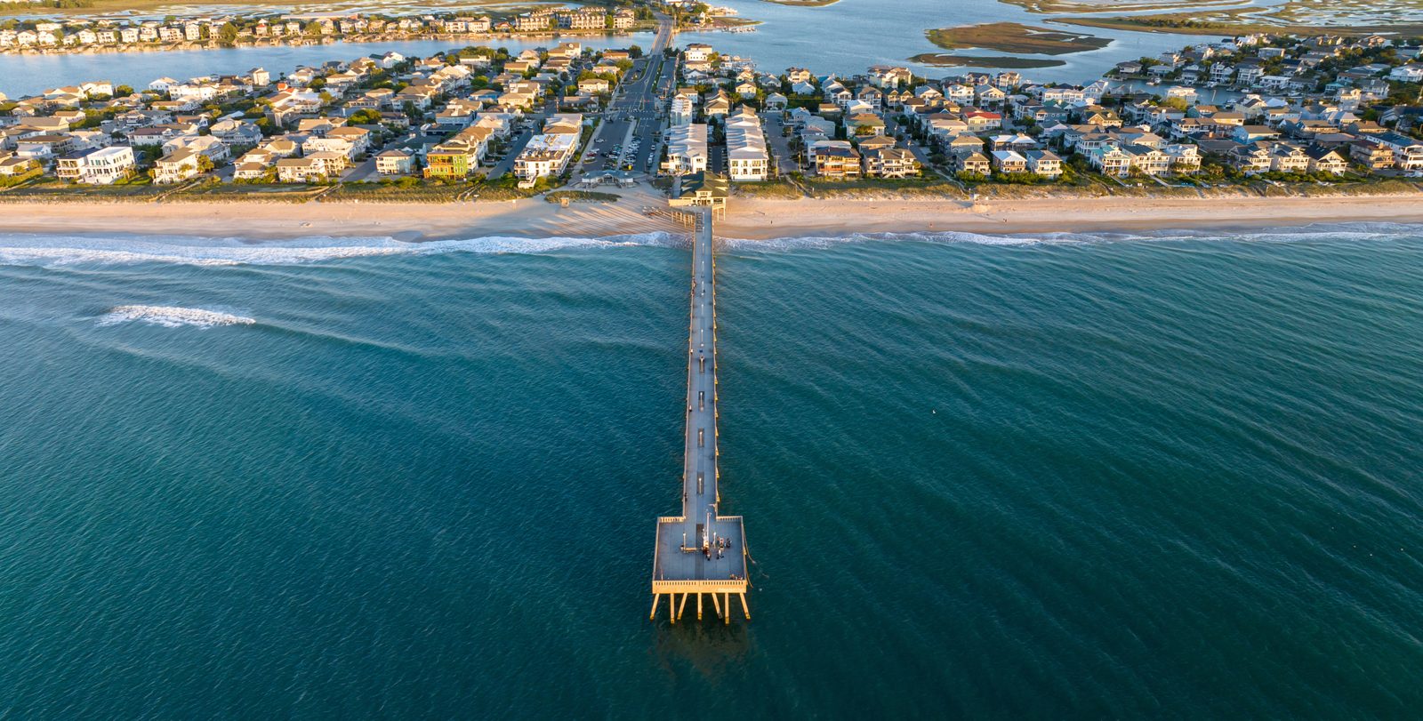 Aerial view of Johnnie Mercers Pier stretching into the ocean at Wrightsville Beach