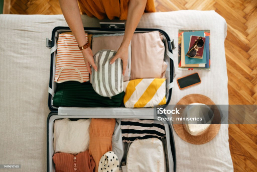 Open suitcase being packed for a beach vacation